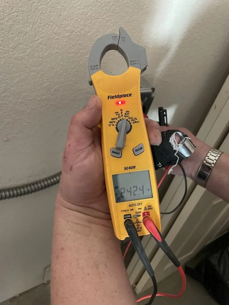 Voltage testing with clamp meter during Outlet Installation in Moultonborough